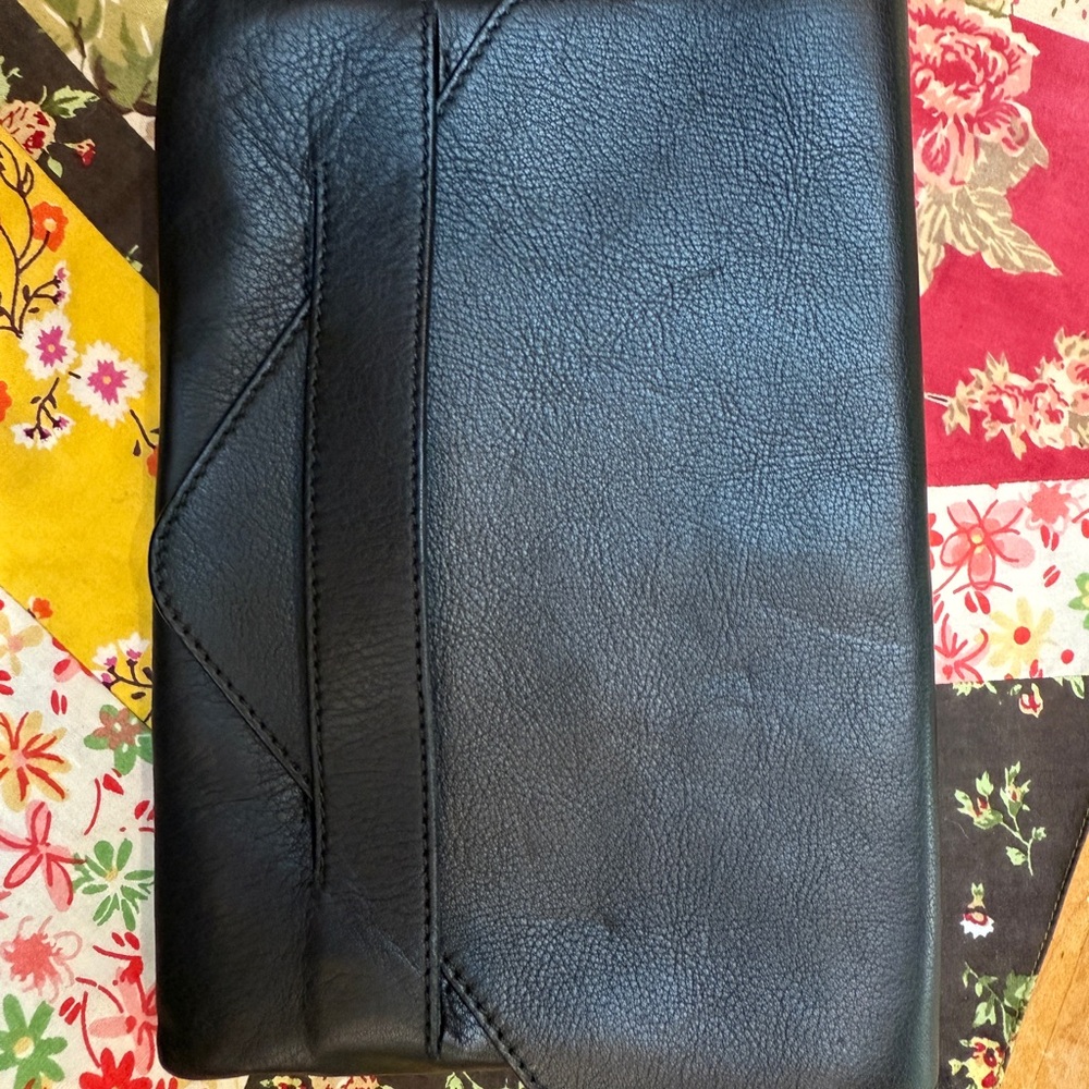 Flat black stylish envelope style bag  . Out to dinner  or evening bag.